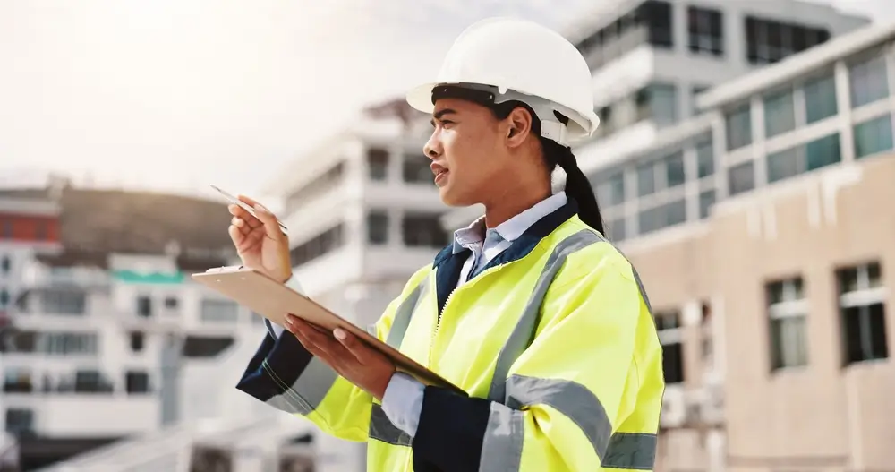 OSHA inspector reviewing safety compliance on construction site.