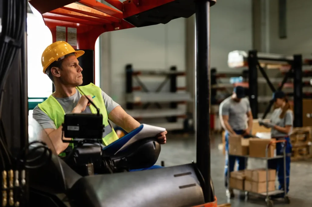 Warehouse workers operating forklifts and checking inventory safely in 2025