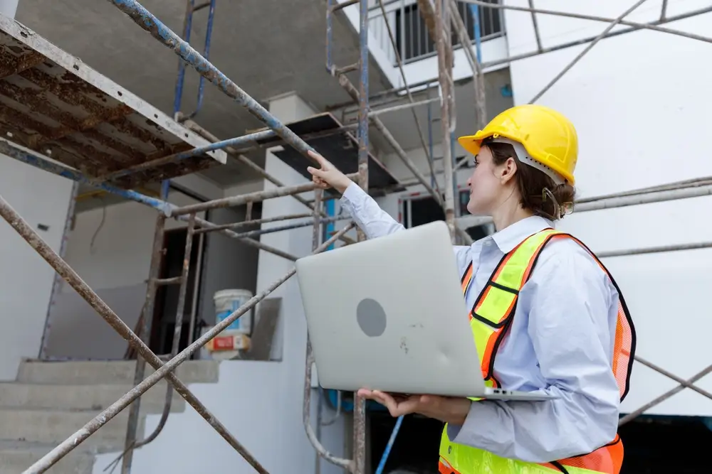 Construction workers safely working on scaffolding with protective equipment