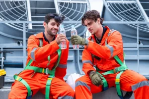 Outdoor worker staying hydrated and cooling off to prevent heat stress on a hot day